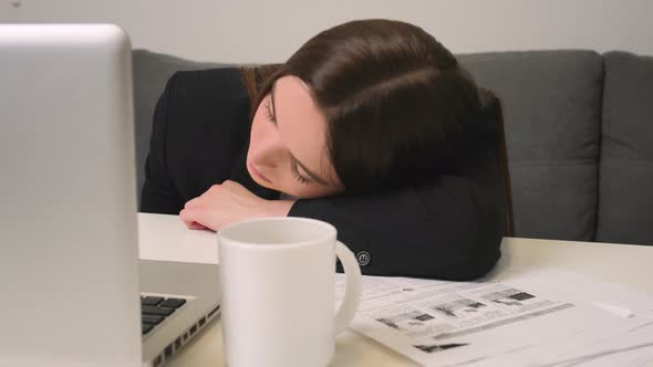 Tired Young Woman Working on Laptop at the Home Office