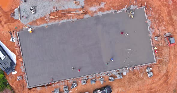 Workers are Using Concrete Polishing Machines for Cement After Pouring Concrete on Foundation Floor