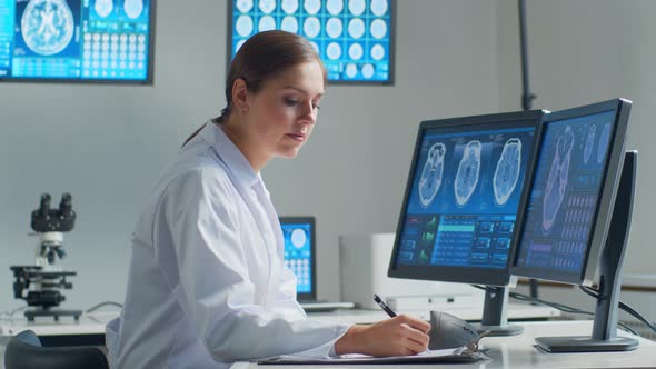 Professional medical doctor working in hospital office using computer technology.