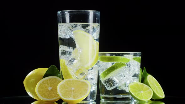 Making Lime and Lemon Cocktail on Black Background