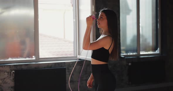 Beautiful Woman Holding Skipping Rope In The Gym