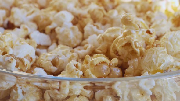 Closeup of Caramel Popcorn Fingers Picking Up a Few and Picking Up Another Handful of Sweet Popcorn