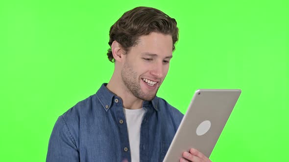 Online Video Chat on Tablet By Young Man on Green Chroma Key