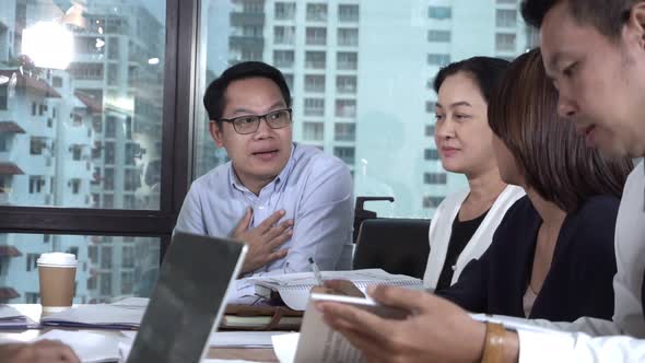 Asian Business People Discuss Marketing Strategy