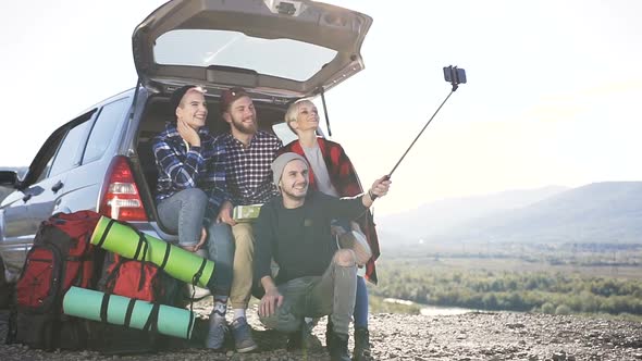 People Doing Selfie, Sitting Leaning on Trunk of Suv Car on Mountain Backdrop Background