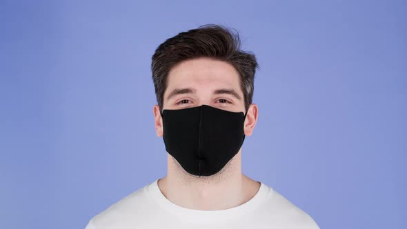 Portrait of Handsome Man in Facial Medical Mask Looking to Camera