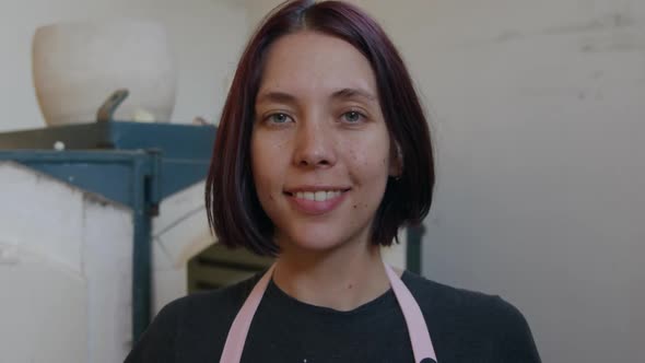 Young female potter working in her studio