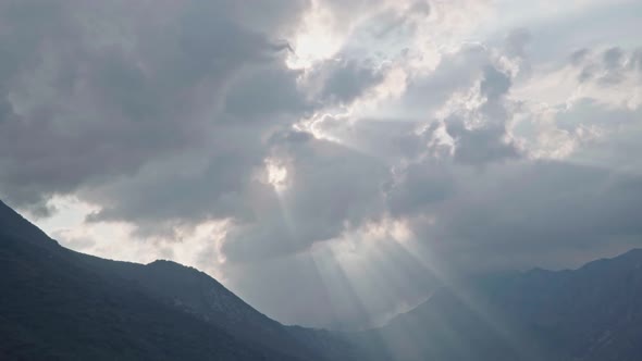 Dramatic Light Through Clouds at Sunset Over Mountains