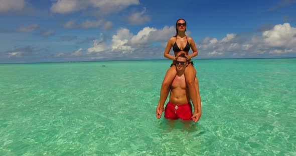 Young boy and girl on romantic honeymoon enjoy luxury on beach on summer white sandy background 4K