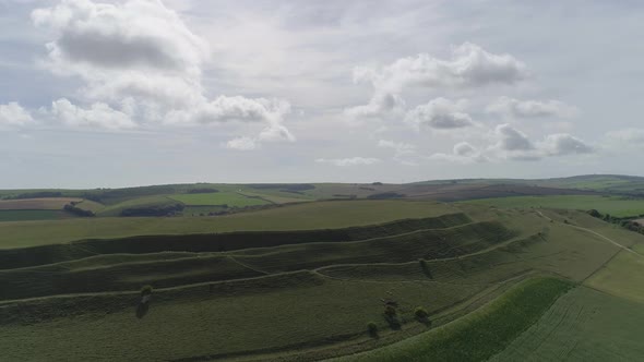 Aerial tracking backwards from Maiden castle on the northern side, to reveal a much greater view of