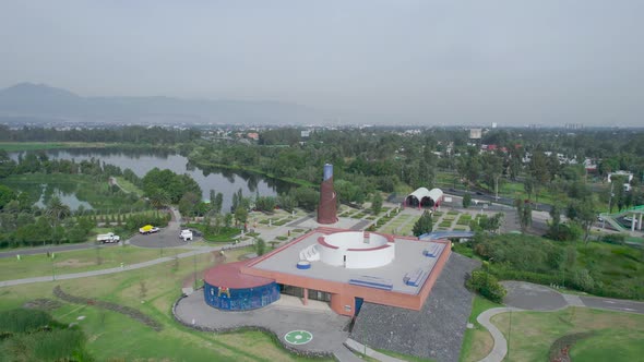 Orbital footage above a lake with view of lake, a highway and a natural area in Xochimilco, Mexico C