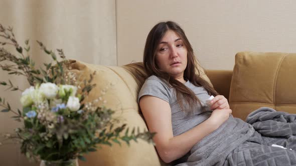 Allergic Woman Sneezes in White Paper Napkin