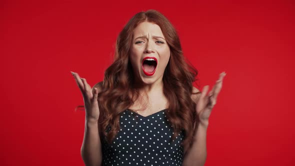 Close Up of Young Frightened Screaming Girl Shocked Isolated Over Red 