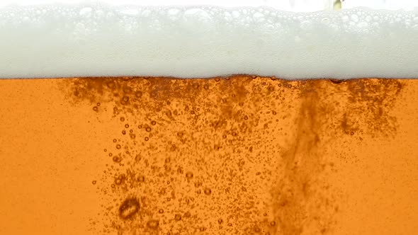 Close up background of beer with bubbles in glass