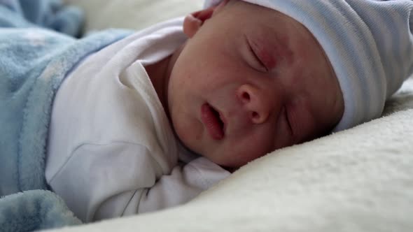 Closeup Crying Newborn Baby Face Portrait Early Days Sleeping On Tummy Blue White Background