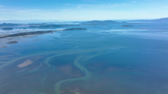 Aerial shot over the water leading to the San Juan Islands.