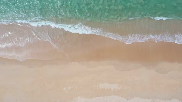 Aerial Top View Wave Swept On The White Sand Beach.