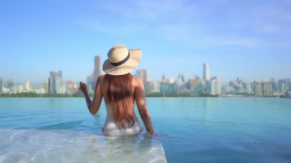 Young asian woman enjoy around outdoor swimming pool for leisure