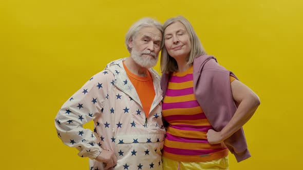 Elderly Man And Woman Come On Yellow Background