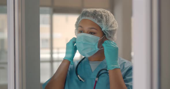 Happy Afroamerican Woman Surgeon Removing Mask and Smiling After Successful Surgery