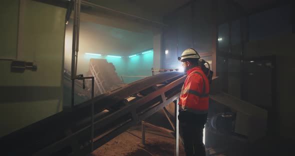 Male Engineer Standing Near Conveyor Belt