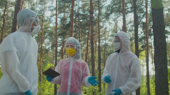 Scientists in Biohazard Suits Exploring Danger Zone