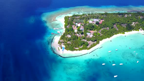 Aerial texture of resort beach by blue lagoon with sand background