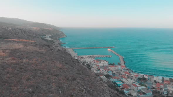 Drone flying towards small town in Greece