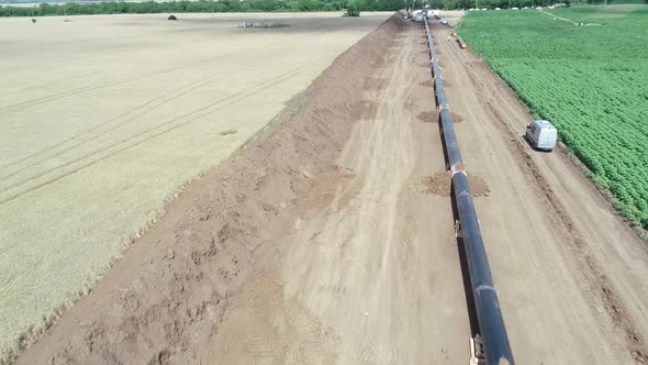Aerial view of gas and oil pipeline construction. Pipes welded together.