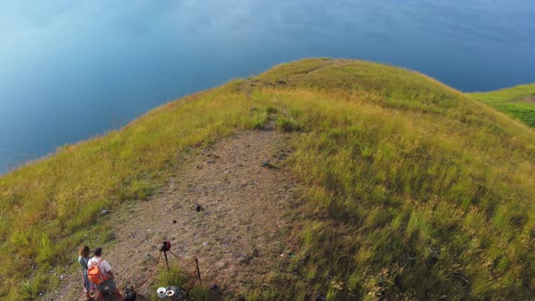 Aerial: couple tourists hiking on Lake Toba Sumatra Indonesia