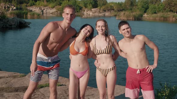 Young Men and Women Posing at Lake