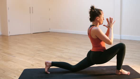 Woman doing stretching exercise on exercise mat