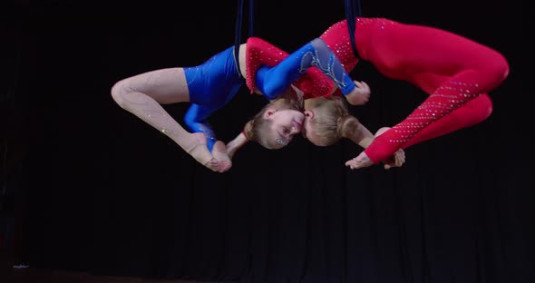 Aerial Gymnastics on Stage Two Teen Girls and Spinning and Arching Their Backs