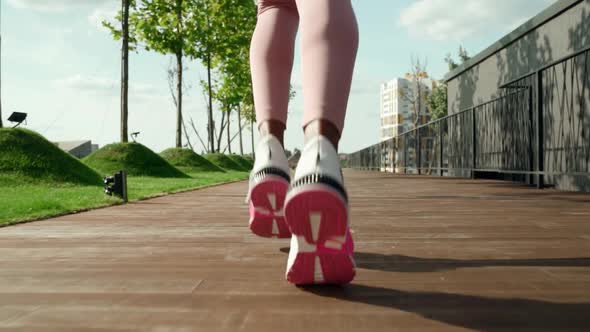 Young Fit Sporty Active Black Woman Running in Sneakers in City Park Outdoors