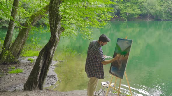 Painter painting in the forest.