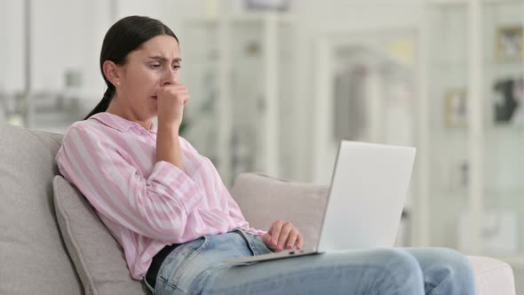 Sick Young Latin Woman with Laptop Coughing at Home 