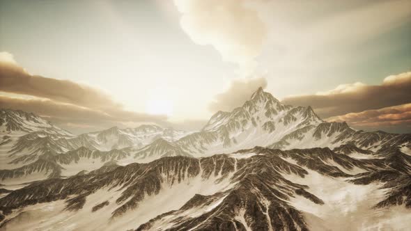 Panorama of High Snow Mountains at Sunset