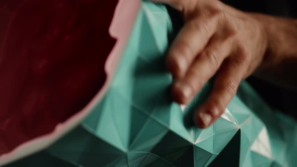 Close-up: pattern vase in the hands of a sculptor artisan artist in the workshop