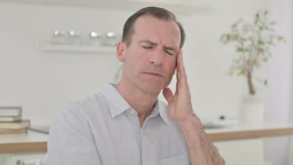 Tired Middle Aged Man Having Headache 