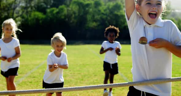 Children playing lemon and spoon race