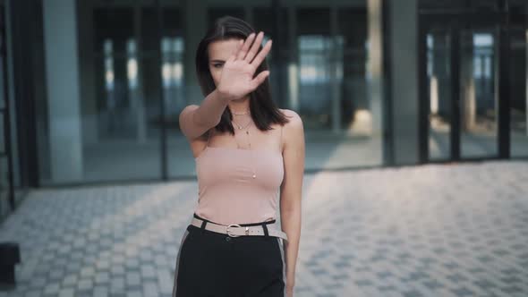 Portrait Slowmotion Video of Young Woman Looks Strictly to the Camera