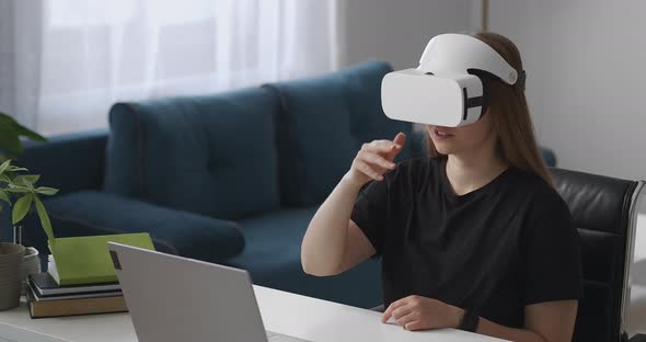 Woman Is Using Vr Headset in Home Swiping and Tapping Virtual Screen Sitting in Room