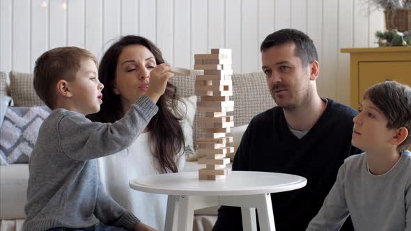 Family Is Playing in Wooden Tower at Home