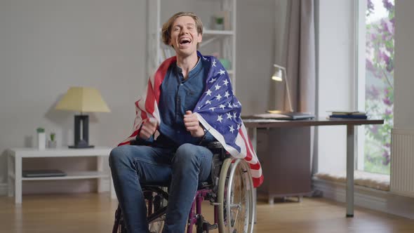 Portrait of Excited Disabled Sport Fan Rejoicing Success Watching TV at Home Indoors Gesturing with