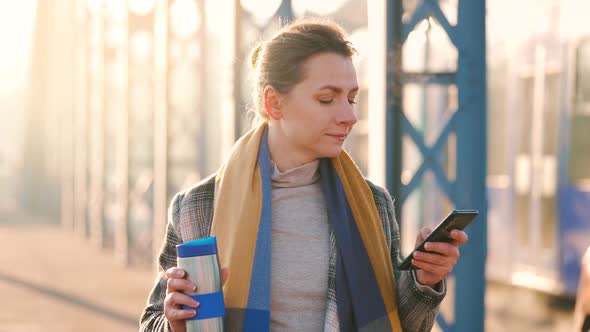 Portrait of a Young Caucasian Businesswoman in a Coat Walking Around the City on a Frosty Morning