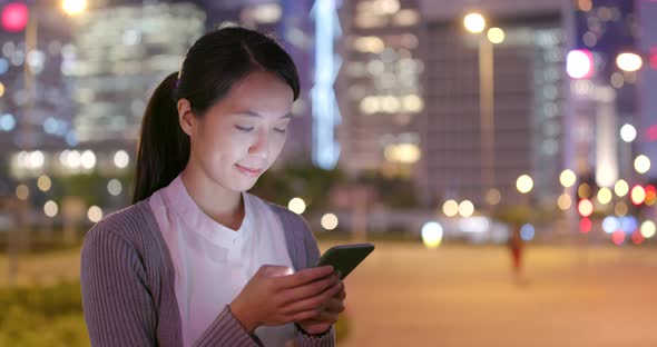 Young business woman work on mobile phone at night