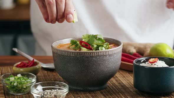 Tom Yam Kung Spicy Thai Asian Soup with Shrimp Rice Seafood Coconut Milk and Chili Pepper in Bowl