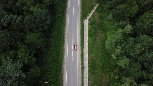 Drone Point of View Tracking Mode Aerial View Flying Over Two Lane Countryside Forest Road with