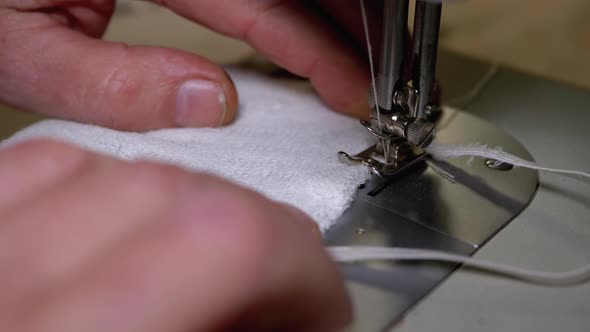 Tailor at Sewing Machine Sews a Homemade Medical Face Mask To Protect Covid-19