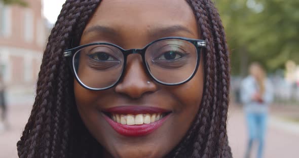 Portrait of Happy Smiling African Woman Standing Outside Looking at Camera